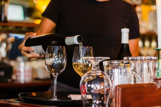 white-wine-pouring-at-bar